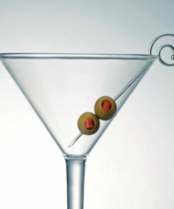 Spiral Stainless Steel Martini Pick in a martini glass with olives